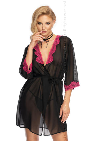 A woman is posing in the Irall Erotic Flavia Dressing Gown by Irall Erotic, a black chiffon robe adorned with pink lace trim. The gown features a plunging neckline and three-quarter sleeves, elegantly cinched at the waist with a matching black belt. She gazes at the camera while gently touching her neck with one hand.