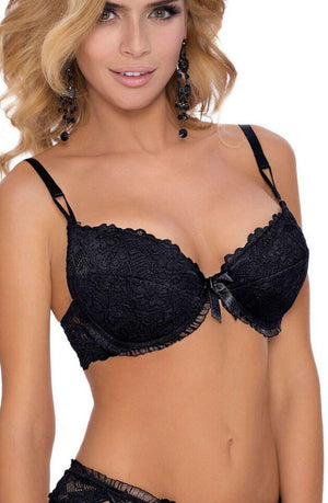 A woman with long blonde hair is wearing an elegant Roza Carmen Black Bra and matching lacy thong. She is adorned with black, dangling earrings and has a slight smile on her face, posing against a plain background.