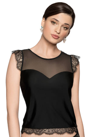 A woman wearing the Roza Erii Black Shirt, a sleeveless top showcasing eyelash lace details on the shoulders and hem. This soft, delicate piece features a sheer mesh panel above the bust. She has short, dark hair styled back and accessorizes with dangling earrings, set against a plain white Roza-box background.