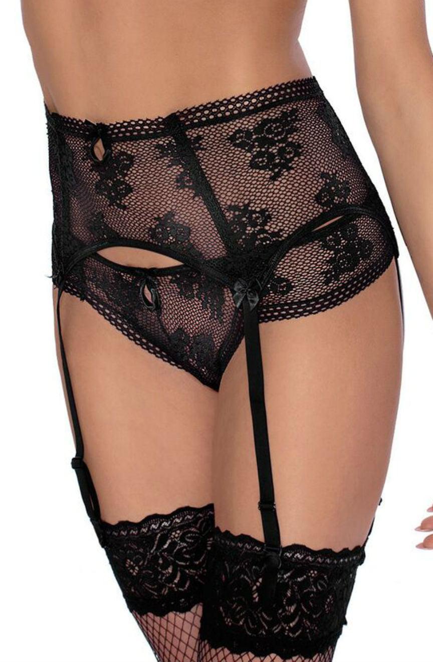 A woman is wearing a sensual black lace suspender belt featuring intricate floral patterns. The high waist design, adorned with small black bows, is paired with the Roza Euterpe Black Thong from Roza and attached to garters that hold up lace thigh-high stockings. She is seen from the midsection down.