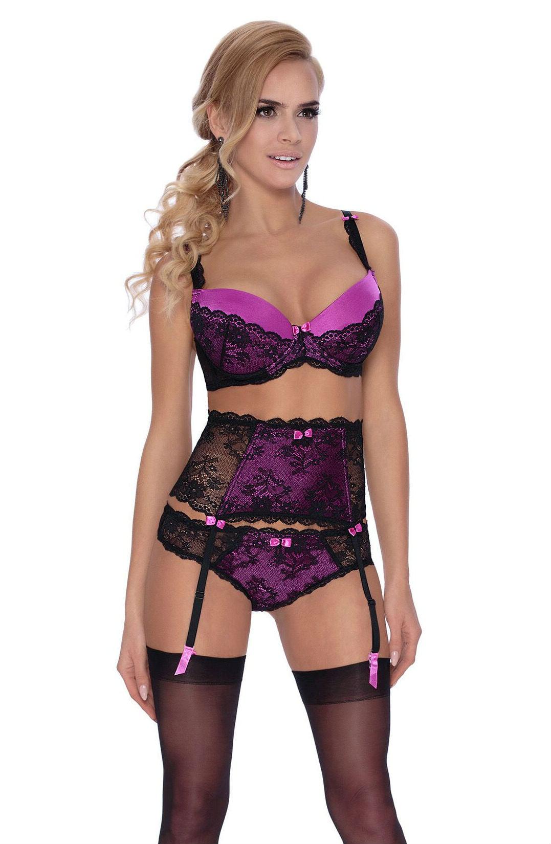 A woman with long, wavy blonde hair stands in a three-quarter view wearing a matching lace lingerie set. The ensemble includes a purple push-up bra with black lace detailing, a black lace suspender belt, and Roza Fifi Thong in black with purple accents. She wears black stockings and stylish earrings.