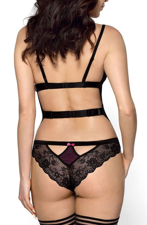 A woman is shown from the back wearing a Roza Fifii Black Body lingerie set, characterized by black lace with purple accents and adorned with satin bows. She has on matching black stockings featuring horizontal stripes at the top. Her long, dark hair cascades down her back. The plain white background accentuates the delicate details of the soft lace fabric by Roza.