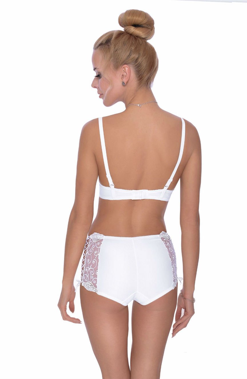 A woman with blonde hair in a high bun is modeling the Roza Ginewra Short White lingerie from Roza, perfect for bridal wear. She is standing with her back to the camera, showcasing a matching push-up bra and panties adorned with lace detailing on the sides. The background is completely white.