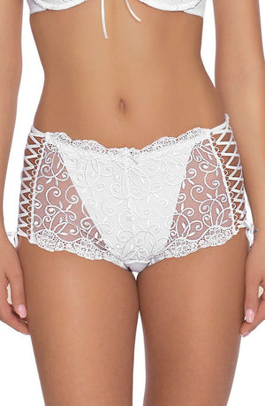 A woman is wearing the Roza Ginewra Short White lingerie set by Roza, featuring intricately designed white lace with sheer panels and floral embroidery, perfect for bridal wear. The set includes a matching push-up bra with lace-up details on the sides and lace trim at the edges. Her midsection is visible, but her face is not shown in the image.