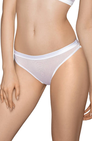 A woman is wearing a Roza Lisbet White Thong bikini-style panty. The fabric is delicate and semi-sheer, subtly revealing her skin tones beneath a charming flower applique. With her hand gently resting on her hip, the close-up showcases her lower torso and upper thighs.