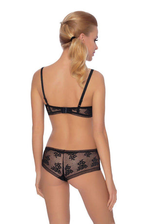 A woman with blonde hair tied in a ponytail is shown from the back, wearing the Roza Nefretete Black Bra and matching panties. This black lace lingerie set with satin ribbon detailing by Roza accentuates her figure as she stands against a plain white background.