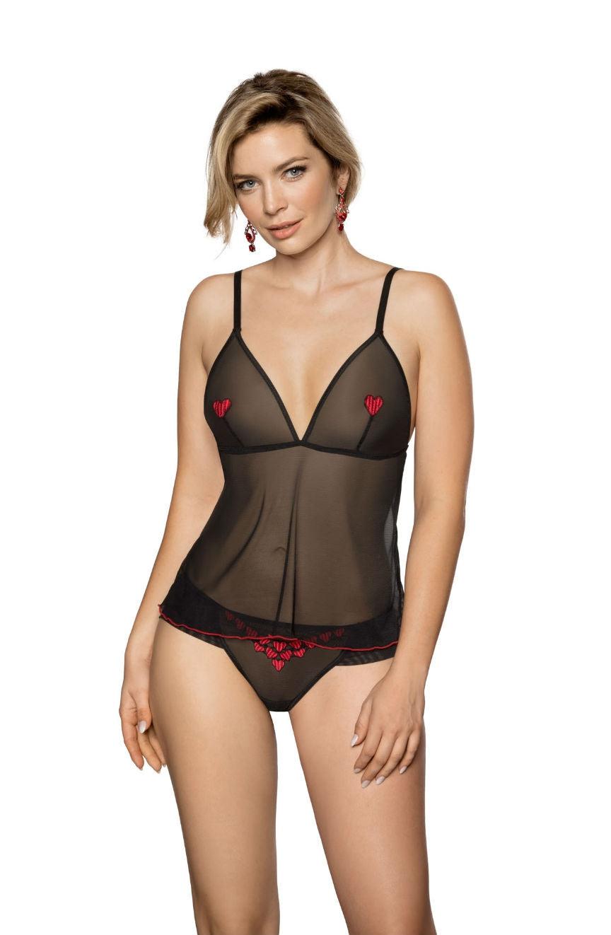 A woman poses against a white background, wearing the Roza Rubii Black Brief with small red heart embroidery on the cups and red floral patterns on the matching sheer tulle briefs. She has short, blond hair and is accessorizing with dangling red earrings, exuding elegance as if she stepped out of a luxurious Roza box.