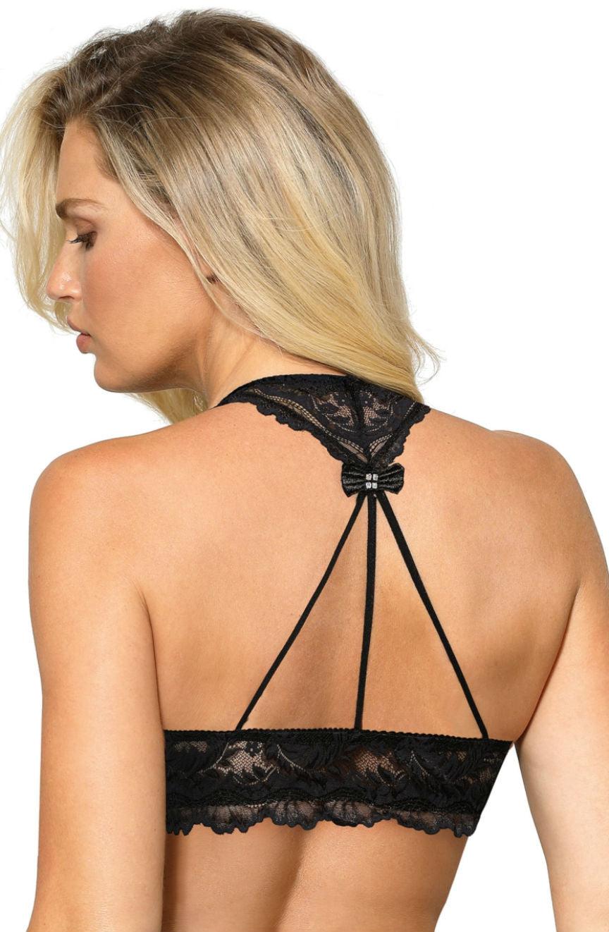 A person with long blonde hair is seen from the back, wearing the Roza Sefia Soft Cup Bra in black by Roza. This bralette features a T-strap design, a decorative bow at the top of the back, and intricate lace detailing around the band and straps, akin to that of a delicate halter neck bra.