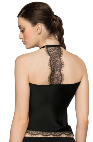 A woman with long brown hair in a braid is shown from the back, wearing the Roza Sija Black Nightshirt by Roza. The black halter top features intricate eyelash lace detailing running down the back and at the hem. The soft stretch fabric adds comfort, while the white background highlights the exquisite design of this nightshirt-inspired piece.