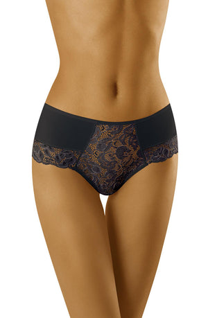 A person wearing high-waisted Wolbar Baha Black Brief lace panties from the Wolbar brand. The image focuses on their lower torso, highlighting the intricate lace detailing at the front of the lingerie paired with smooth fabric on the sides. The white background beautifully accentuates the garment.