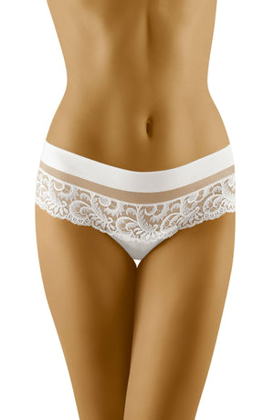 A close-up of a woman's lower torso wearing the Wolbar Cantata White Thong Shorts. These stylish panties from Wolbar feature an elegant lace panel with a solid white waistband and a delicate floral lace pattern covering the front. The woman's skin is a warm, tan color.