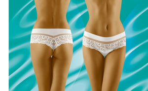 Two views of a person wearing Wolbar Cantata White Thong Shorts: one from the back and one from the front, showcasing the elegant design. The background features a turquoise abstract pattern with wavy, light blue lines.