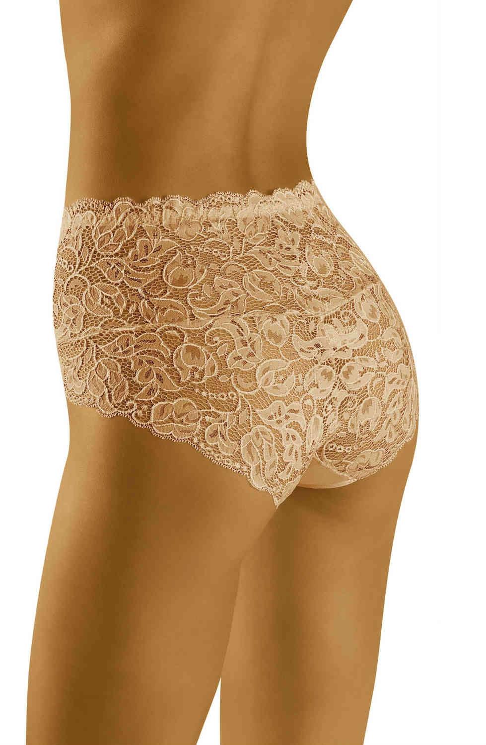 A close-up view shows a person wearing the Wolbar Teri Beige Brief from Wolbar. The image highlights the intricate floral lace detailing and the perfect fit of this lingerie piece, covering the lower back and partial hips. The skin tone is a warm, medium shade.